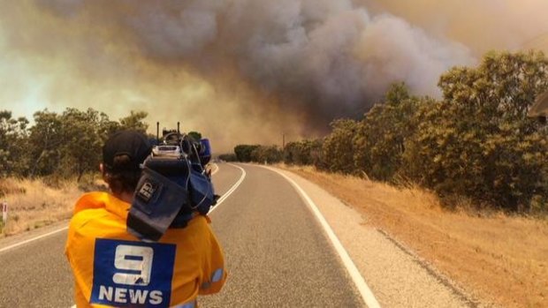 A Nine News cameraman captures vision of the Bullsbrook blaze.