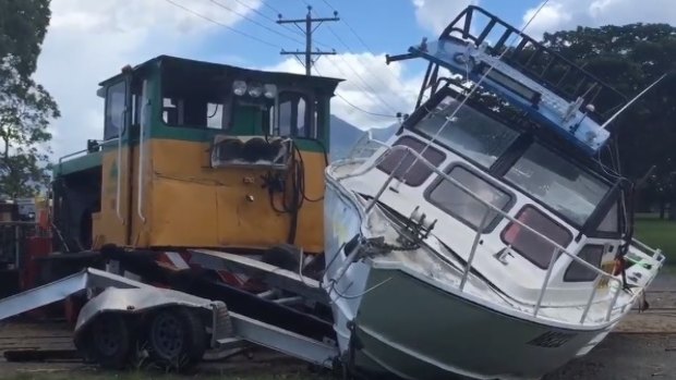 A cane train has derailed after hitting a fishing boat just after 1pm.