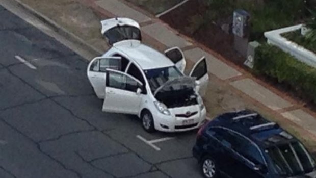 Police officers searched a white Toyota Yaris on Trickett Street for explosives.