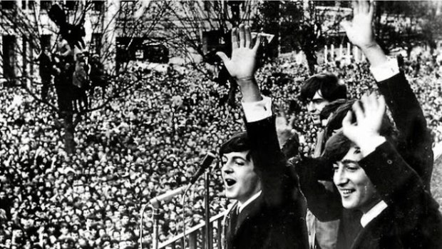 The Beatles wave to fans at the Melbourne Town Hall in 1964.