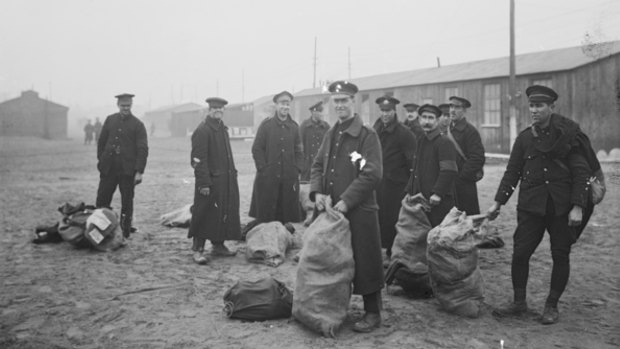 An group of repatriated British and Australian prisoners of war at a base depot, where they had received a much-needed change of clothes.