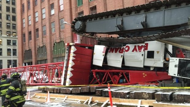 Debris and a mangled crane lie in the street in New York's Tribeca neighbourhood.