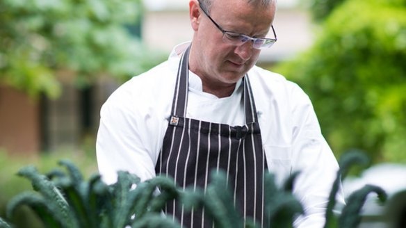 Michael Ryan picking kale at his Beechworth restaurant Provenance.