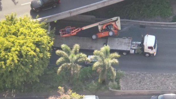 A truck has lost a cherry picker it was carrying after hitting a pedestrian bridge in Kangaroo Point.