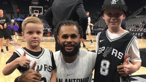 San Antonio Spurs NBA player Patty Mills greeting Luke Allen after winning a competition for his Game Day! book