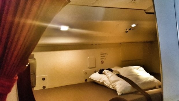The small bed flight attendants sleep in on the world's longest flight: Qatar Airways' Auckland to Doha route.