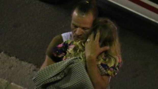 A man and child after a truck mowed down people during Bastille Day celebrations in Nice. 