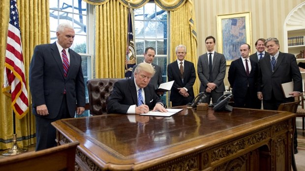 US President Donald Trump signs an executive order reinstating the gag rule prohibiting receivers of aid from discussing abortion.  
