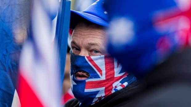 A True Blue Crew member wears an Australian Flag on his face during a protest organized by the anti-Islam True Blue Crew supported by the United Patriots Front in Melbourne.