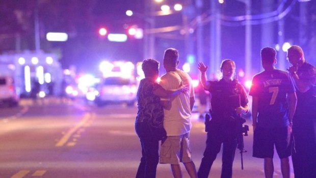 Police officers direct people away from the Pulse nightclub in Orlando.
