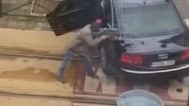 Police point their weapons in the direction of an injured terror suspect in Brussels.