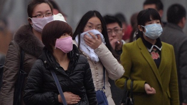 Chinese commuters wear face masks as heavy air pollution shrouds Beijing in February 2014. China's cities are often hit by heavy pollution, blamed on coal-burning by power stations and industry, as well as vehicle use.