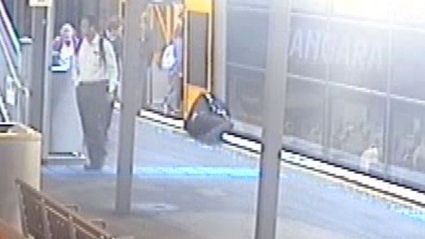 A man lies on the ground after falling while running for a train.