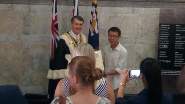 Lord Mayor Graham Quirk poses for photos with a new citizen.