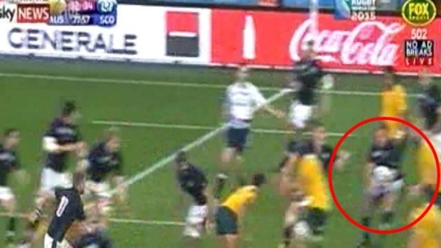 Controversial: Scotland's Jon Welsh instinctively grabs the ball.