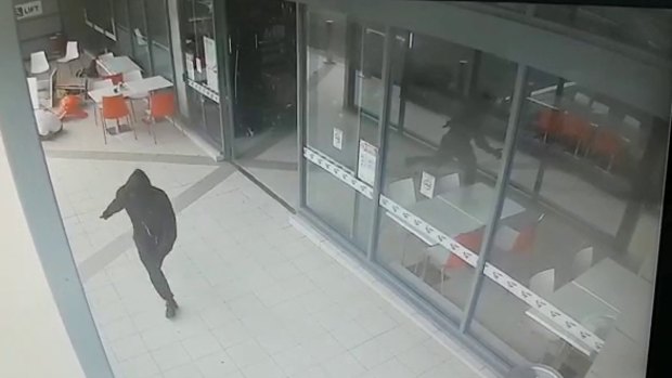 A hooded figure runs from Bankstown Central after shooting Wally Ahmad on April 29, 2016.