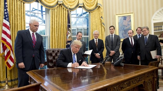 US President Donald Trump signs an executive order reinstating the gag rule prohibiting receivers of aid from discussing abortion.  