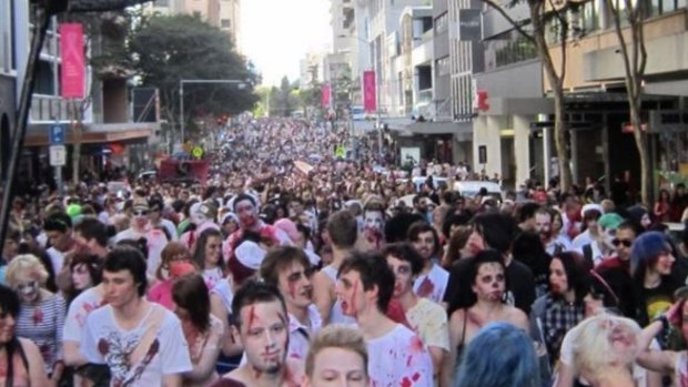 Blood-soaked shuffling crowds enjoy the Brisbane Zombie Walk.