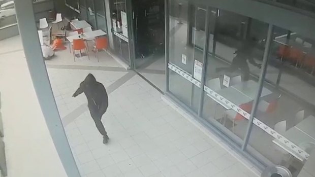 A hooded figure runs from Bankstown Central after shooting Wally Ahmad on April 29, 2016.