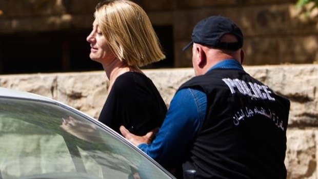 60 Minutes reporter Tara Brown escorted from court in Beirut on Monday.