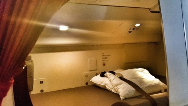 The small bed flight attendants sleep in on the world's longest flight: Qatar Airways' Auckland to Doha route.
