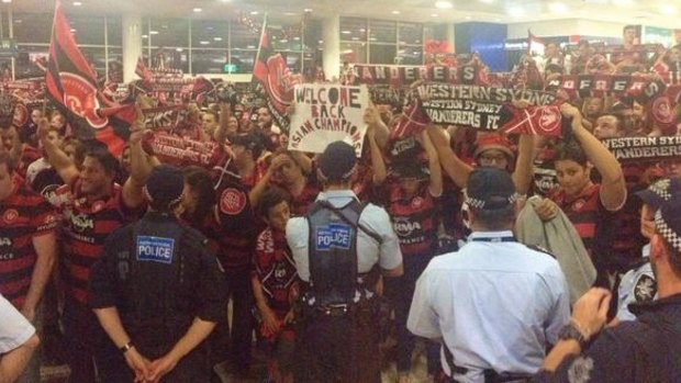 Proud bunch: Wanderers fans in the arrivals hall.