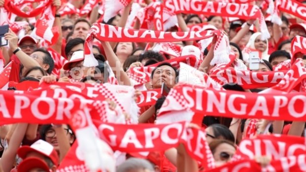 People take to the streets during Singapore's National Day Parade at Padang on Sunday. 