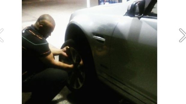 7-Eleven employee helping a young Melbourne woman change her tyre. 