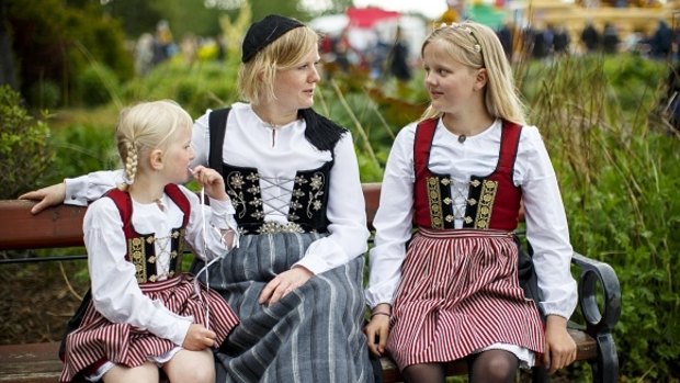 A woman and two girls are seen in traditional dress as Icelanders celebrate the Icelandic National Day in Reykjavik, Iceland on June 17, 2016.