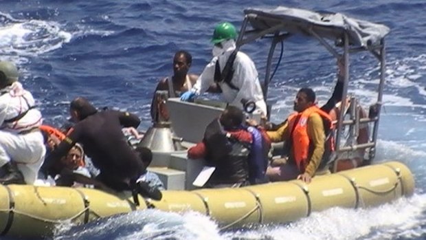 Survivors are rescued after their boat capsized off the coast of Libya.