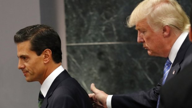 Donald Trump walks with Mexican President Enrique Pena Nieto, during a Presidential campaign visit.