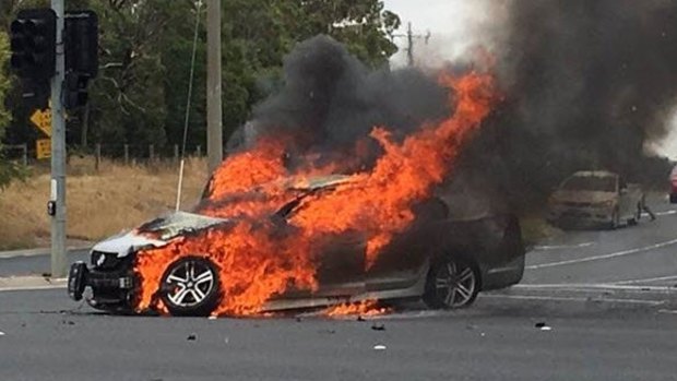 A vehicle in flames following a three-car collision in Keysborough. 