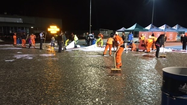 Emergency services workers and Love Your Sister volunteers clean up the coins on Wednesday night. 