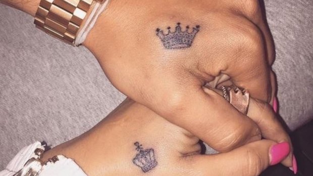 His and hers crown tattoos.