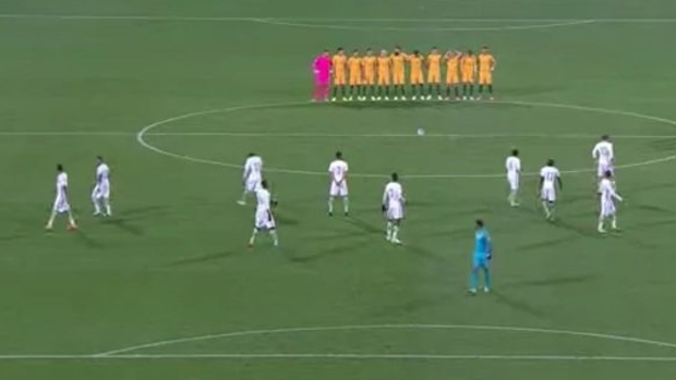 Controversial moment: The Australian players stand arm-in-arm in remembrance as Saudi counterparts fail to do likewise