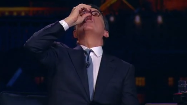 Cheers to that! Urgant gives Colbert a shot of vodka.