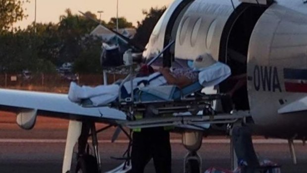The crocodile attack victim is put aboard an RFDS plane.