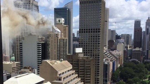 Smoke billows from the top of a Sydney building. 