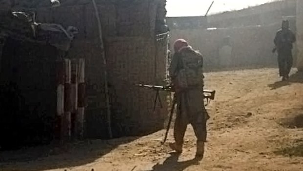 Taliban fighters take up positions in Kunduz on Monday. 