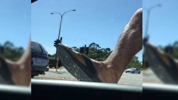 Thongs and all, the driver's mirror is on the receiving end of a hefty kick.