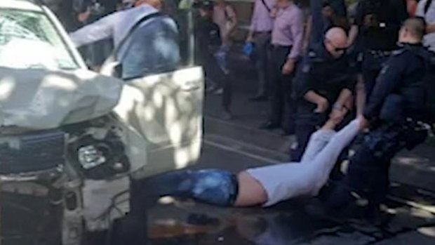 A man is dragged from a car in Flinders Street after an attack that left more than a dozen people injured
