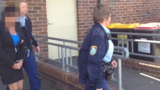 Police lead "Betty Colt" from court when she is sentenced.


 