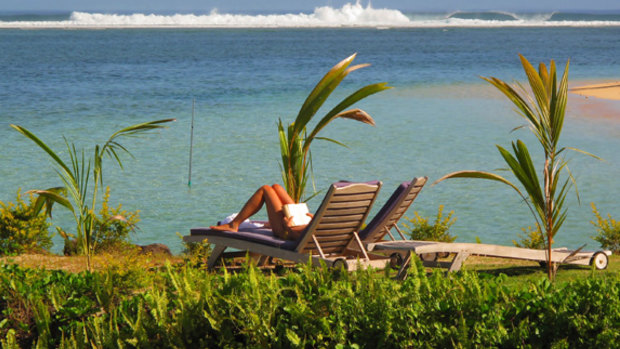Business as usual on Savai'i as a tourist relaxes in the sun.
