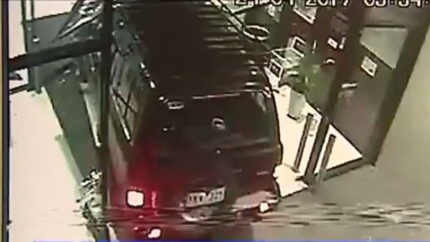 An image of the LandCruiser ramming the doors of the shopping centre.