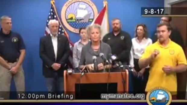 A screenshot from a Manatee County news conference on September 8 in which sign language interpreter Marshall Greene (yellow shirt) baffled the deaf and hard of hearing.