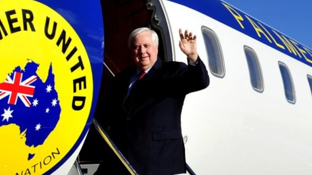 Clive Palmer boards his private jet on the campaign trail.