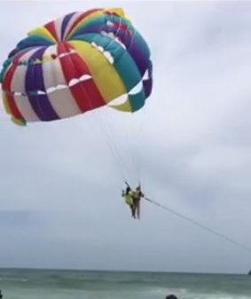 Mr Hussey and a beach crew member in flight before he fell.