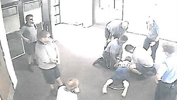 CCTV images appear to show a teenager with ankle-cuffs being held down at the Townsville centre.