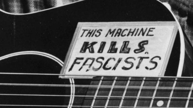 Woody Guthrie's motto on his guitar: "THIS MACHINE KILLS FASCISTS".