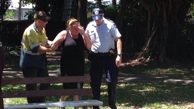 Police and residents at the scene of the Cairns stabbing.